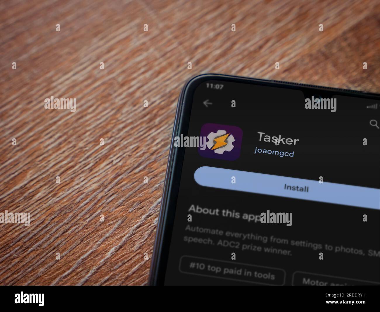 Lod, Israel - July 16,2023: Tasker app play store page on smartphone on  wooden background. Top view flat lay with copy space Stock Photo - Alamy