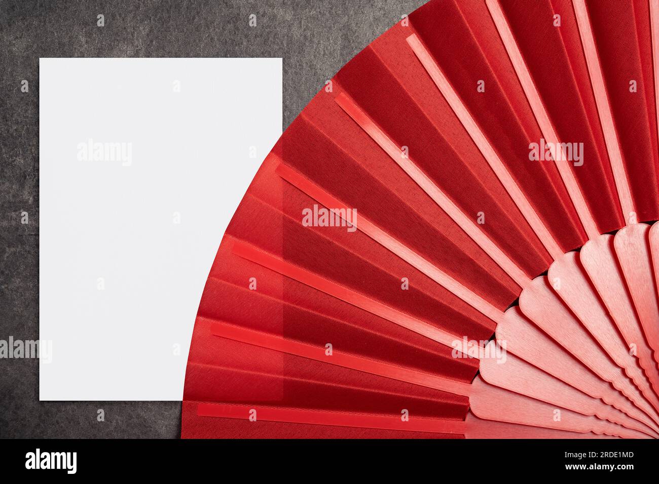 Red Chinese fan with empty paper for copy space on black background ...