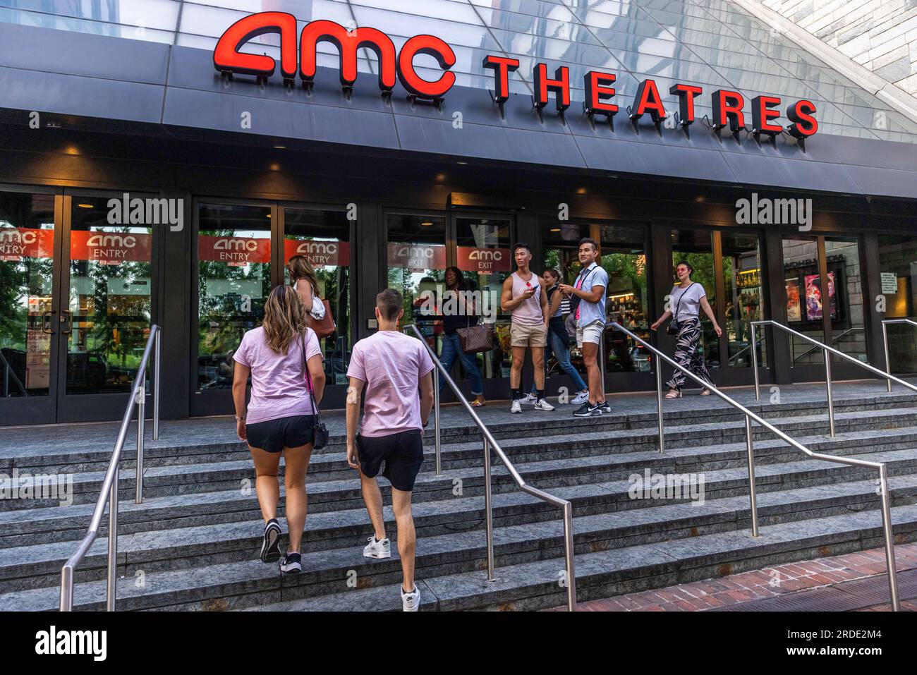 Washington DC, July 20, 2023. People dressed in pink enter AMC Theaters ahead of a showing of 'Barbie' during its debut at AMC Georgetown in Washington DC on July 20, 2023. The movie, released the same day as 'Oppenheimer' will be the first major motion pictures released during the actor and writers strikes that have suspended most Hollywood productions, including promotional materials for the two movies. Stock Photo