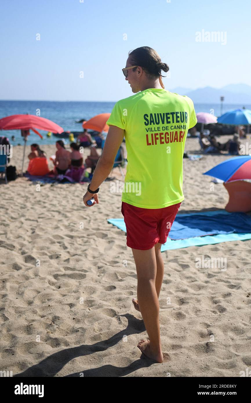 Cannes, France. 20th July, 2023. A lifeguard checks water's temperature