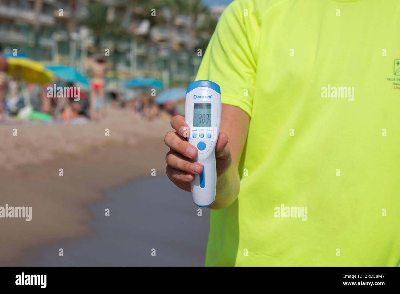 Cannes, France. 20th July, 2023. A lifeguard checks water's temperature