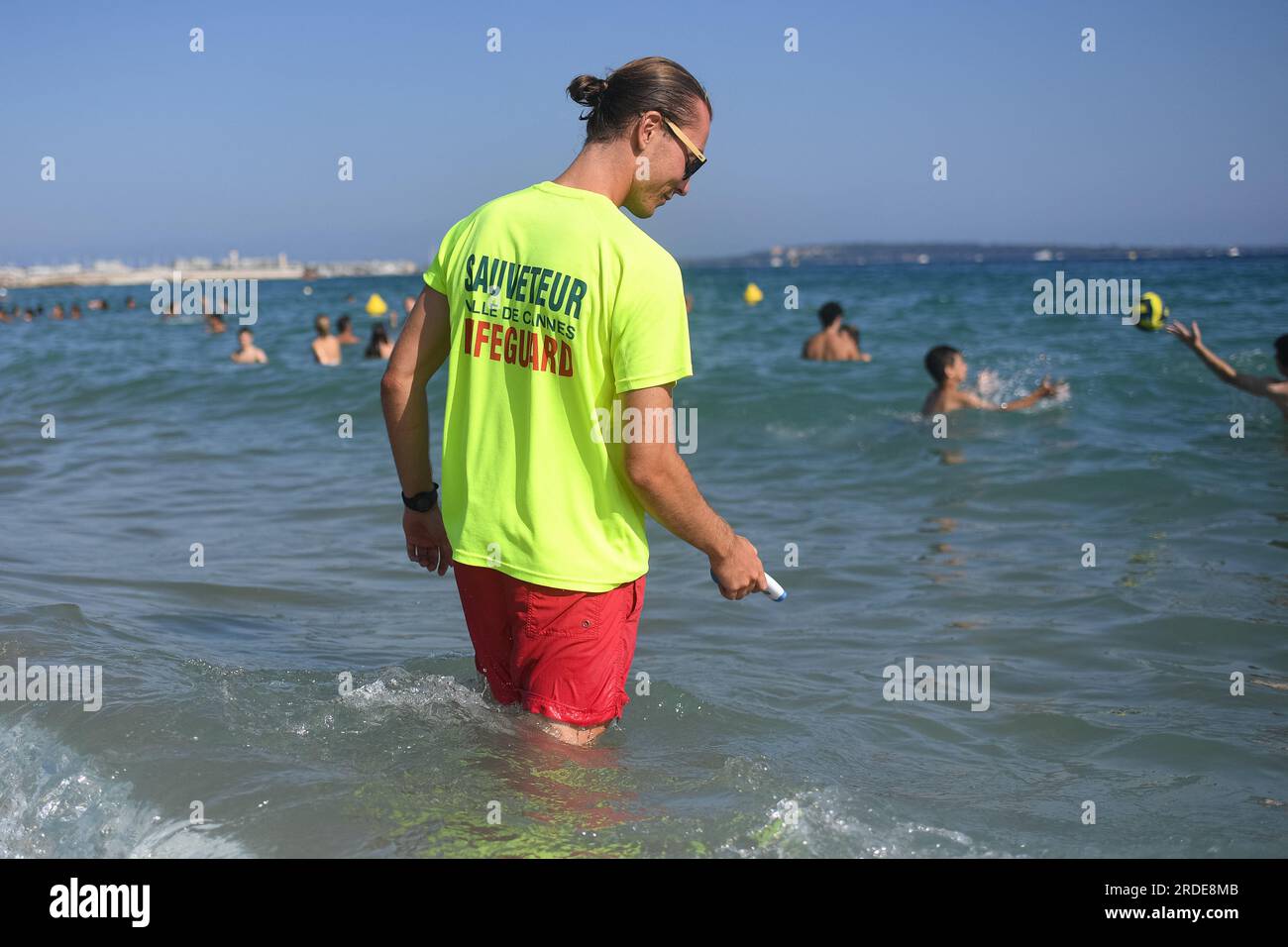 Cannes, France. 20th July, 2023. A lifeguard checks water's temperature