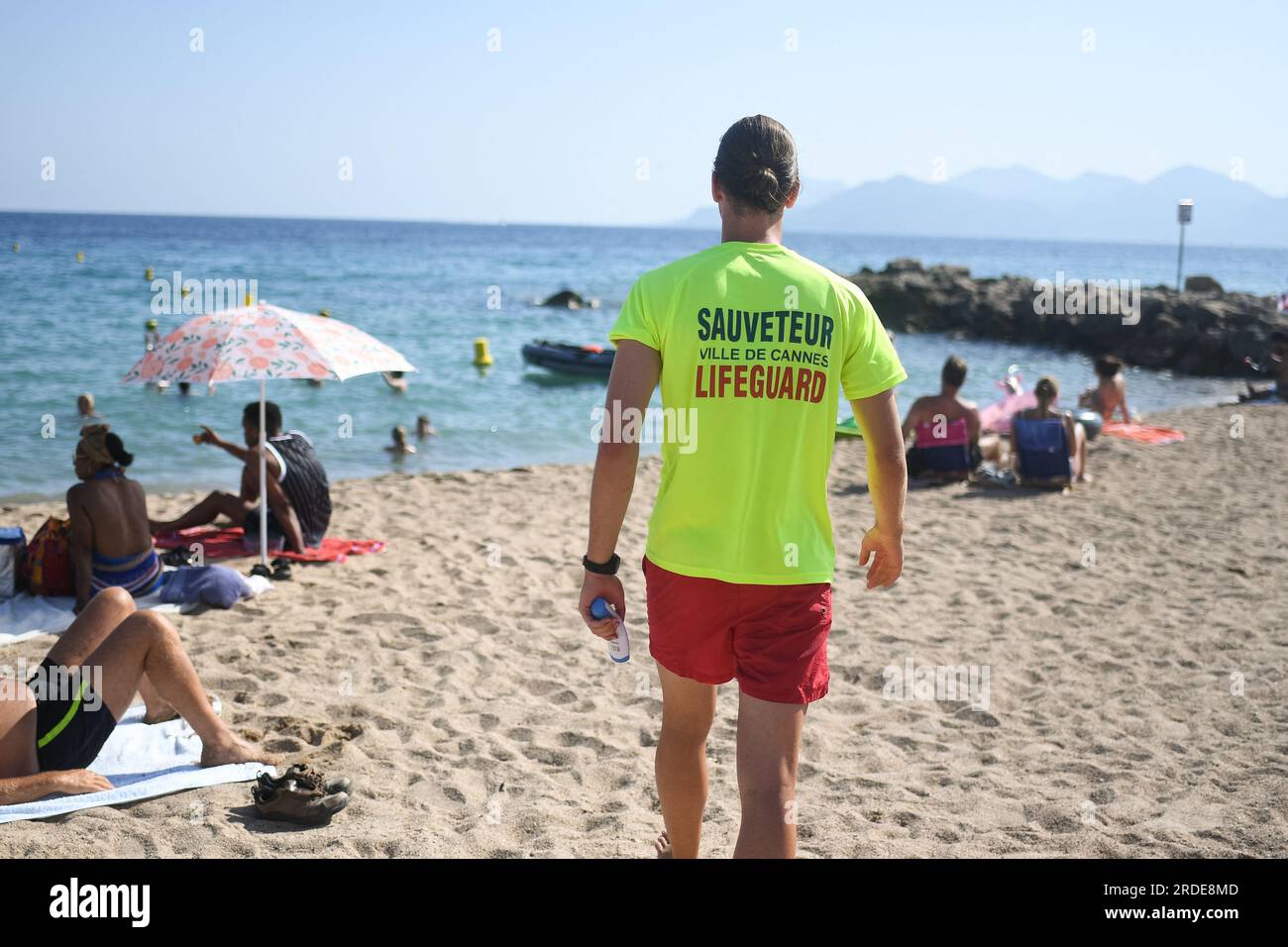 Cannes, France. 20th July, 2023. A lifeguard checks water's temperature