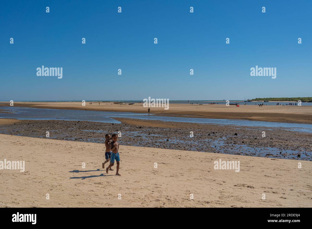 Morondava, Madagascar - May 30.2023: Two boys at the river during low tide in Morondava harbour. Stock Photo