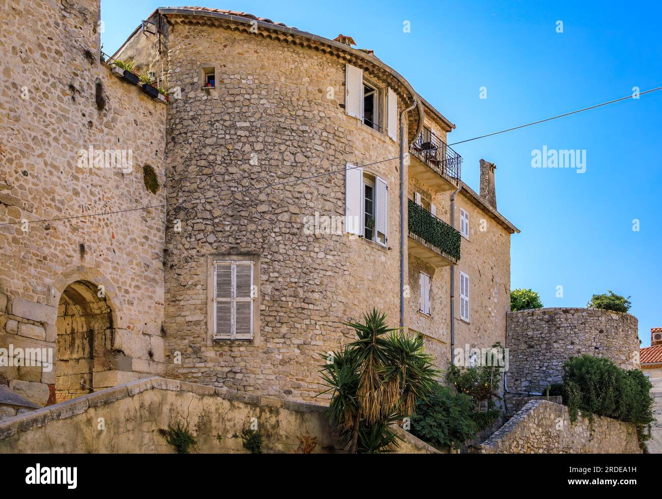 Medieval stone city walls near the local provencal farmers market in the old town or Vieil Antibes, South of France Stock Photo