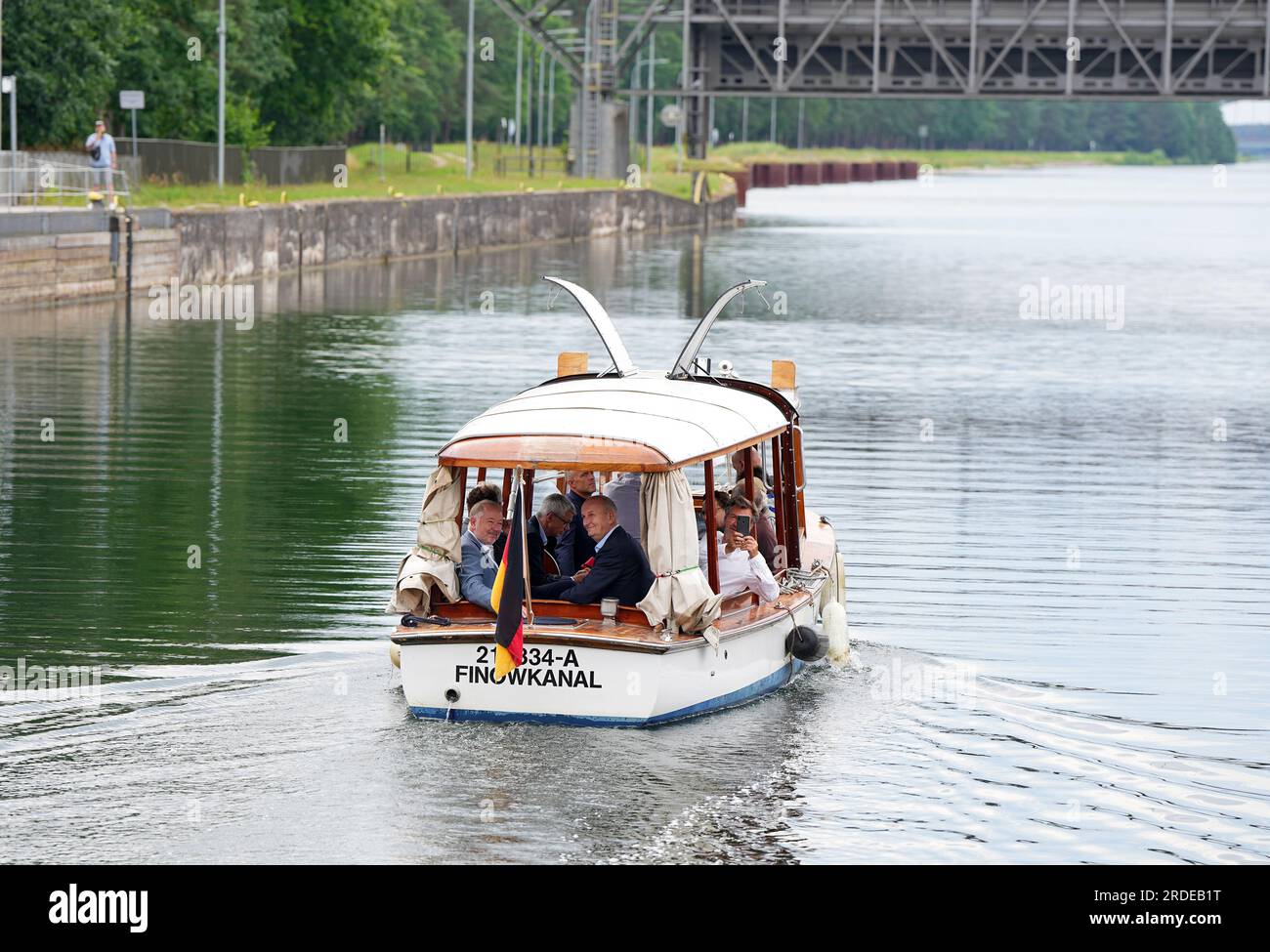 Niederfinow, Germany. 19th July, 2023. Dietmar Woidke (r, SPD), Minister President of Brandenburg, and Jan Mönikes (l), Managing Director of SHW Tourismus- und Wirtschaftsentwicklungsgesellschaft Niederfinow mbH, sit in the saloon boat 'Funtensee' during the traditional summer tour of the old ship lift in Niederfinow. The historic boat had been put into service in 2019 on the Königsee in Bavaria and brought to Niederfinow by the non-profit association 'Unser Finowkanal e.V.'. During the tourism press trip was visited the region Barnimer Land. Credit: Soeren Stache/dpa/Alamy Live News Stock Photo