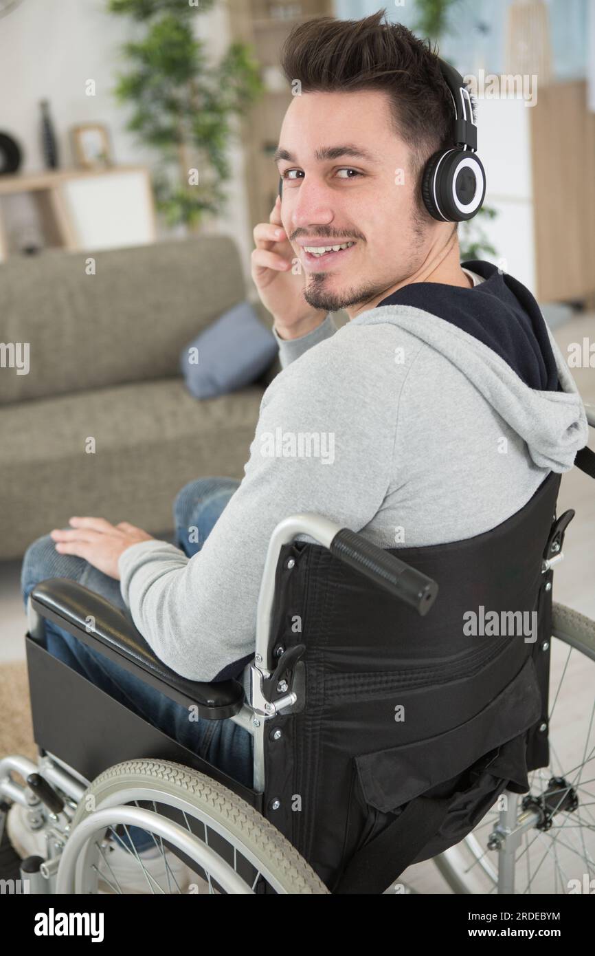 Young Man In A Wheelchair Wearing Headphones Stock Photo - Alamy