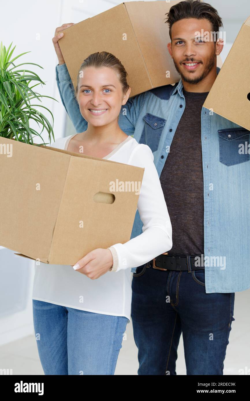 young couple carrying their boxes Stock Photo - Alamy