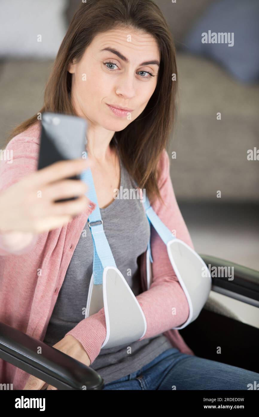 cheerful smiling woman in the wheelchair using her smartphone Stock ...