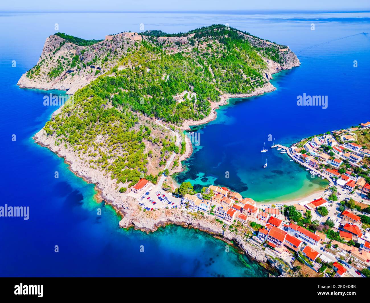 Assos, Greece. Picturesque village, colorful houses and turquoise colored bay. Idyllic Kefalonia, Ionian islands aerial view. Stock Photo