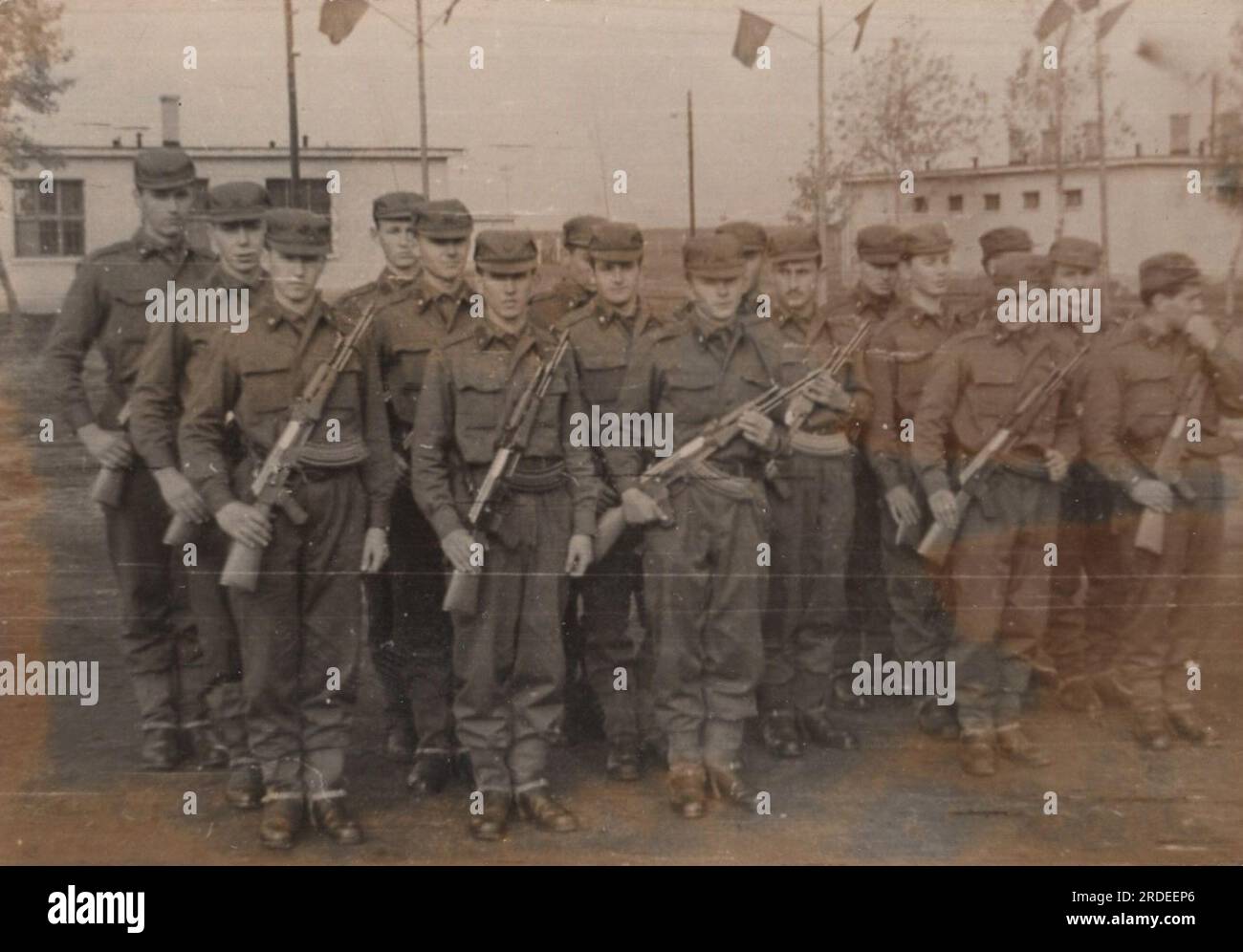 young military cadets in somewhere in Europe  under the Soviet Union protection. behind the iron curtain at the 1950s. They have got machine gun AK47. (  Kalashnikov rifle ) Stock Photo