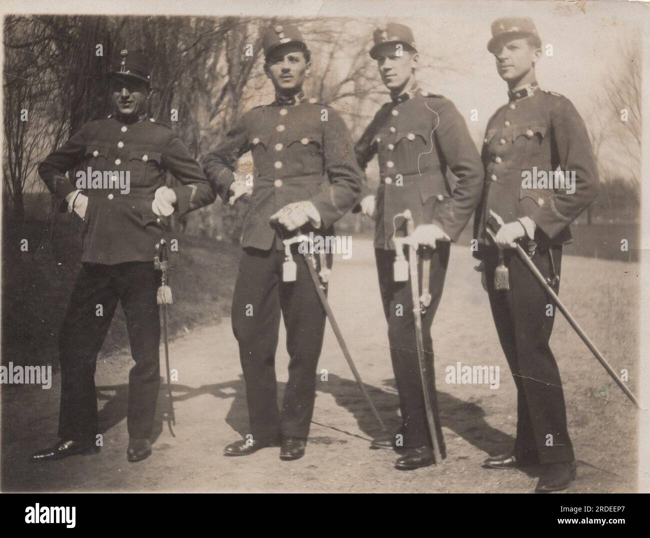 young austro-hungarian military officers just graduated at the military academy. they are posing with them ceremonial uniform with sword. they are ready to serve them empire. Stock Photo