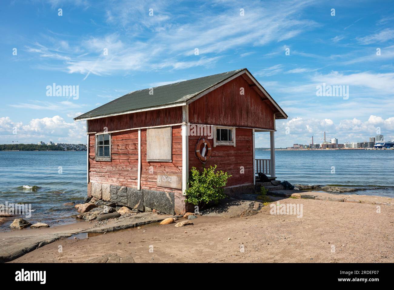 Old weathered fisherman's cabin in Pihlajasaari island waterfront on a sunny summer day in Helsinki, Finland Stock Photo