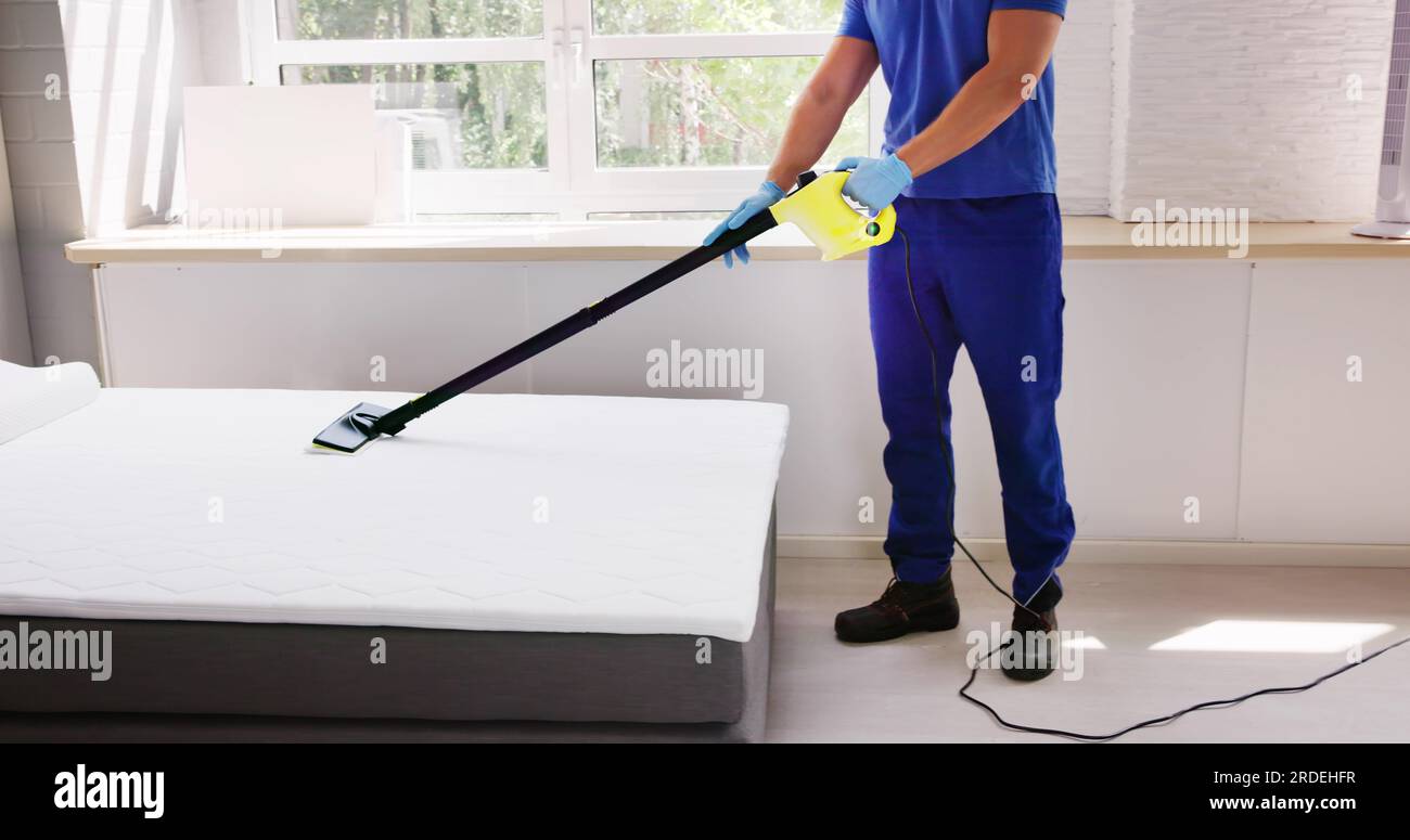 Cleaning Bed Mattress With Steam Machine. Bed Bugs Treatment Stock