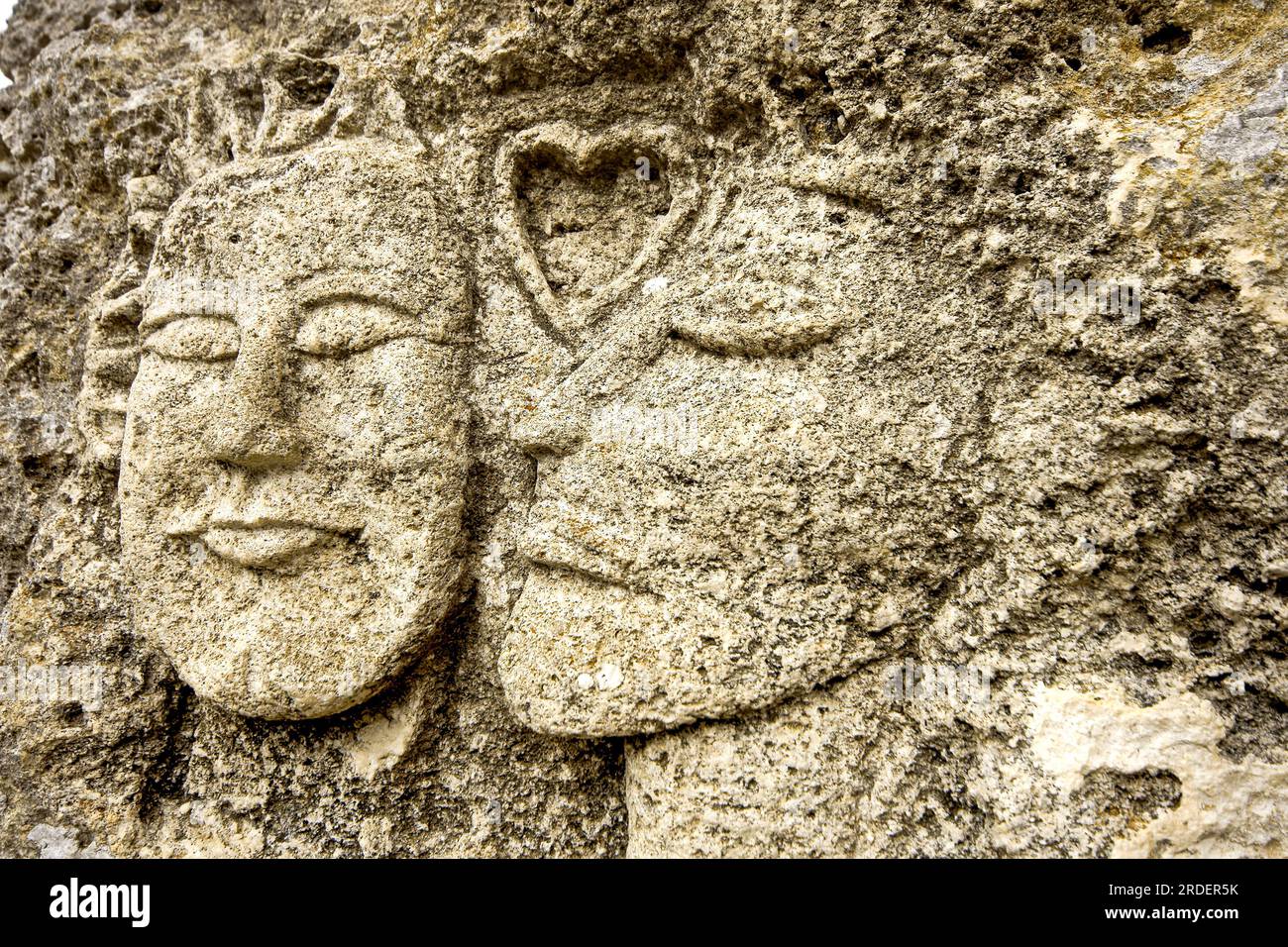 faces carved in a cliff 'hippies'. Necropolis hypogea de Calescoves. Alaior. Menorca. Baleares. Spain. Stock Photo