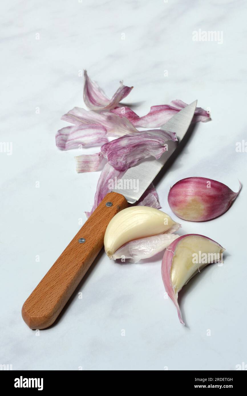 Fresh red garlic cloves with knife, France Stock Photo Alamy