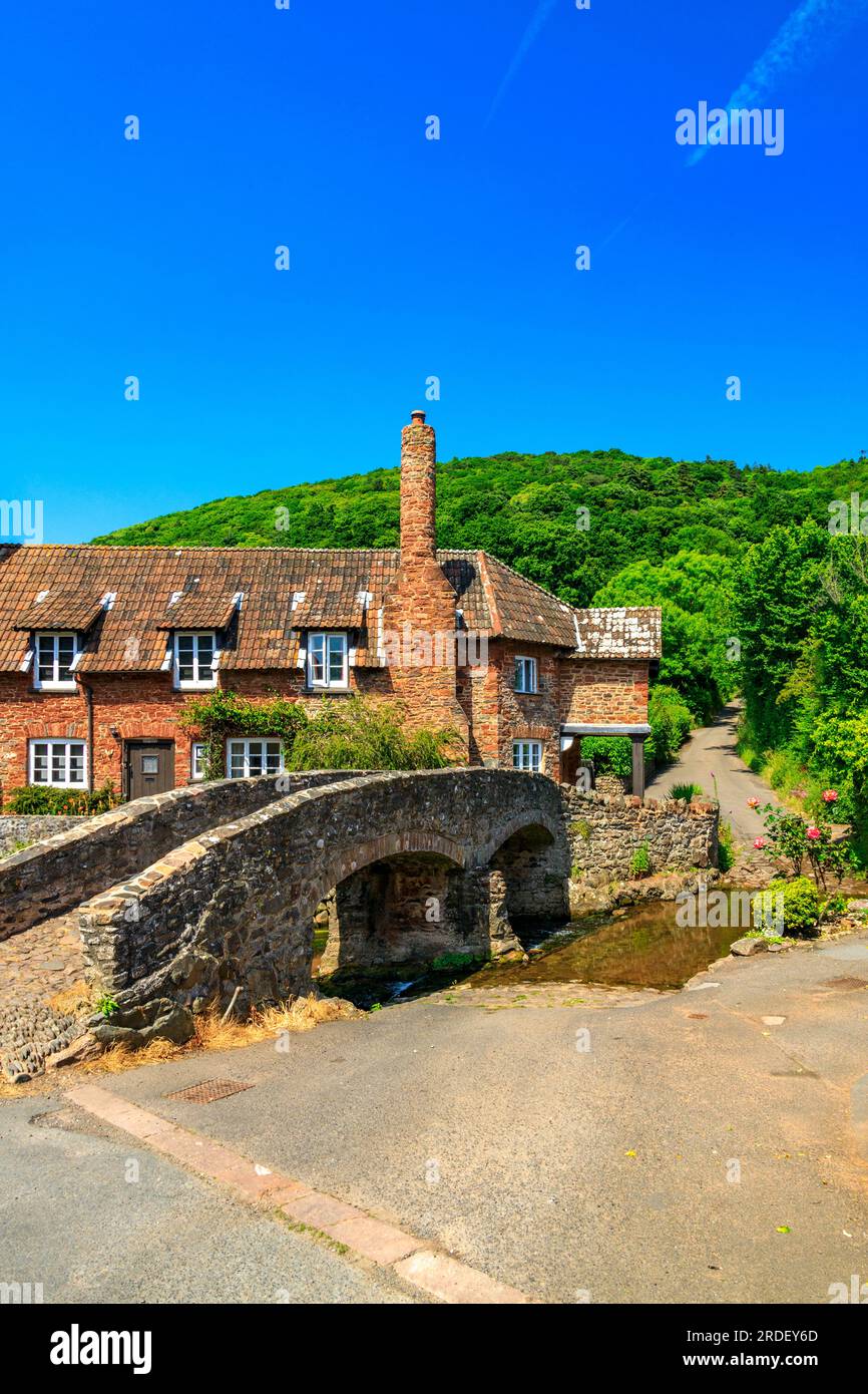 Traditional stone cottages and the historic pack horse bridge at Allerford on the Holnicote