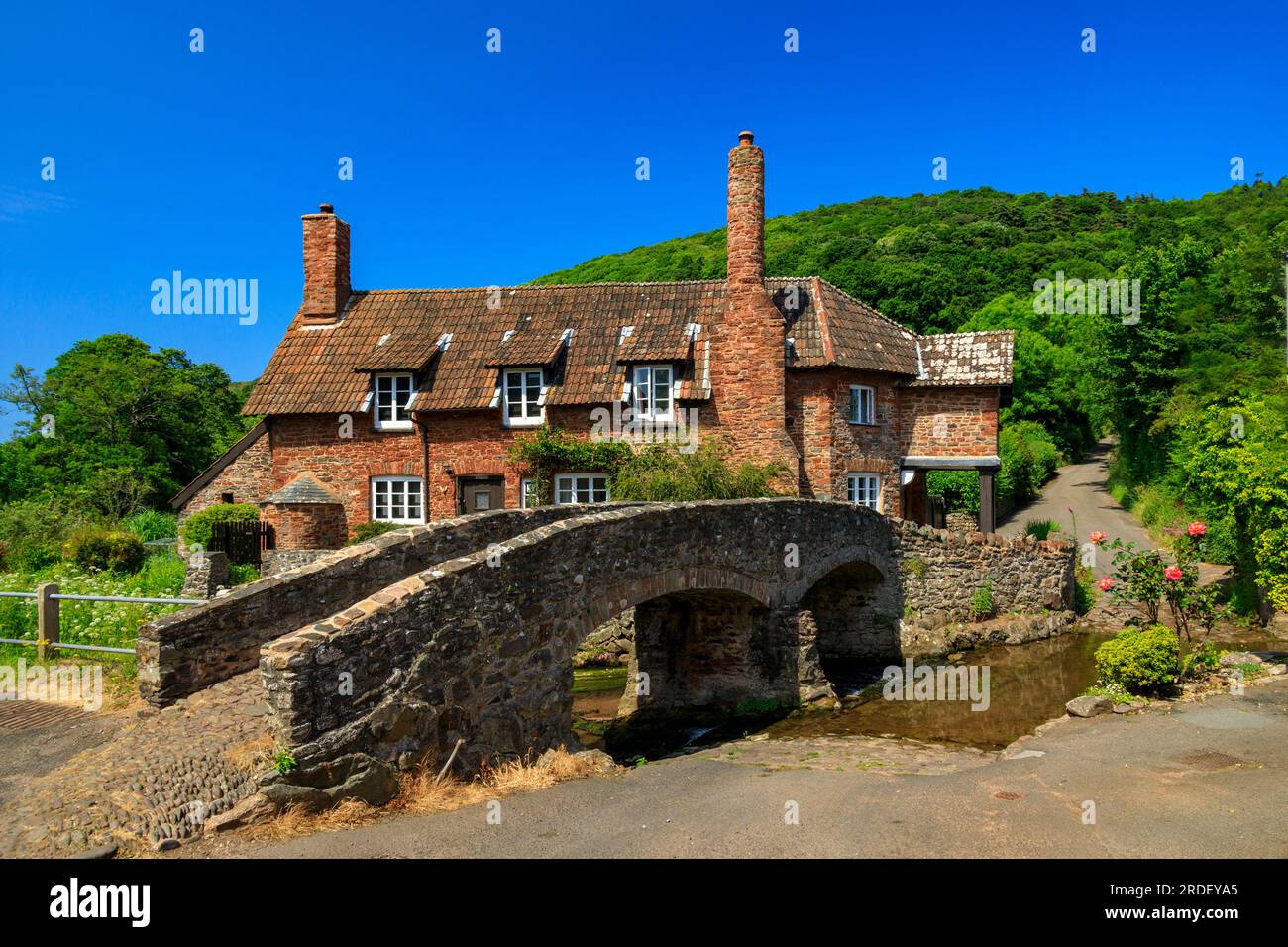 Traditional stone cottages and the historic pack horse bridge at Allerford on the Holnicote