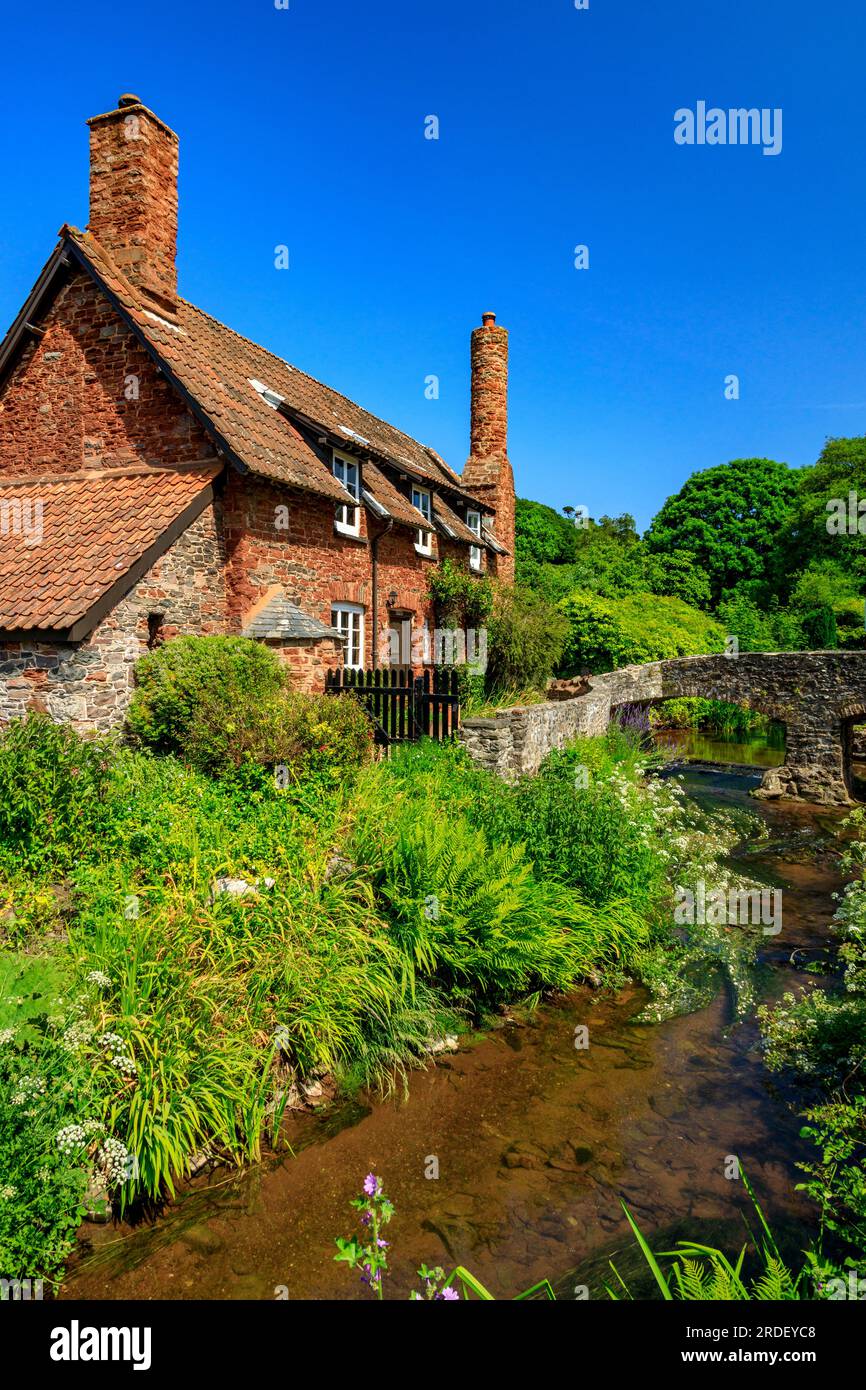 Traditional stone cottages and the historic pack horse bridge at Allerford on the Holnicote