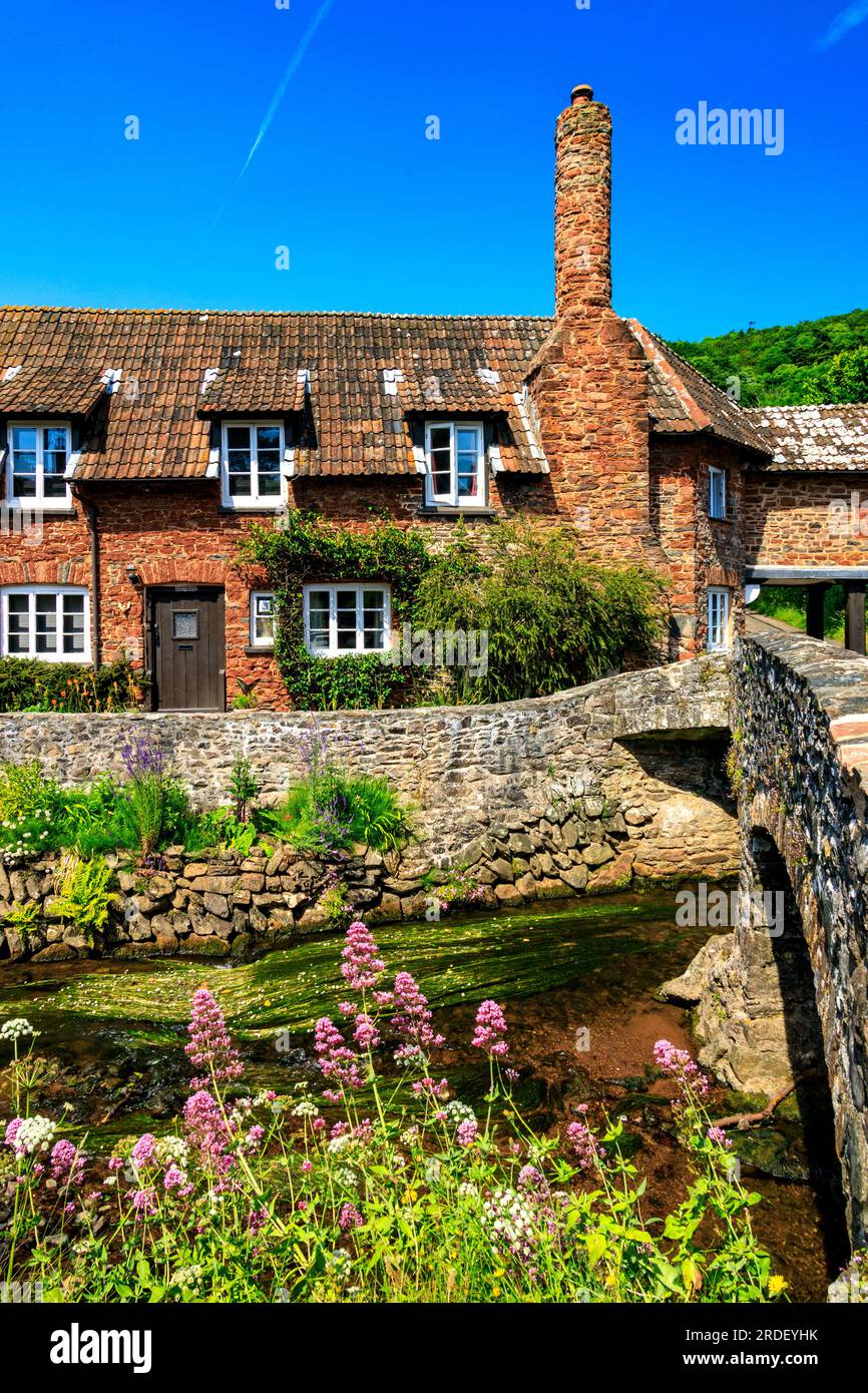 Traditional stone cottages and the historic pack horse bridge at Allerford on the Holnicote