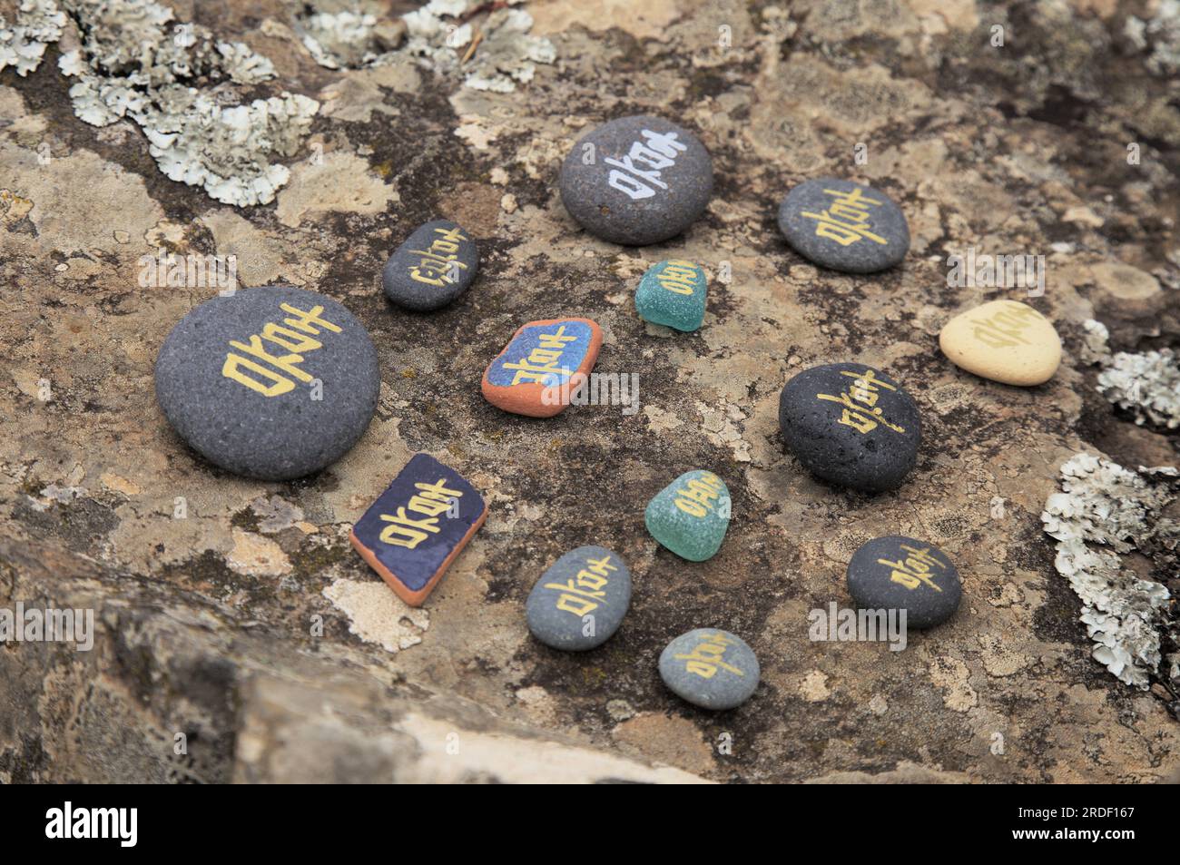 Chinese character xi or Japanese ki, meaning joy, written on a volcanic rock pebbles and sea-rounded tile shards Stock Photo