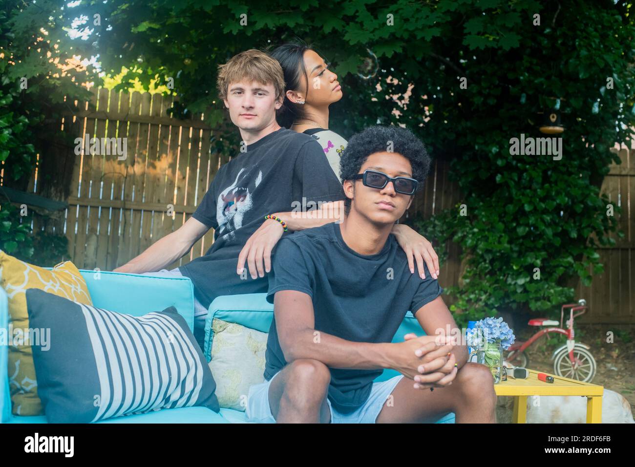 Mod Squad of teens hang out in backyard Stock Photo