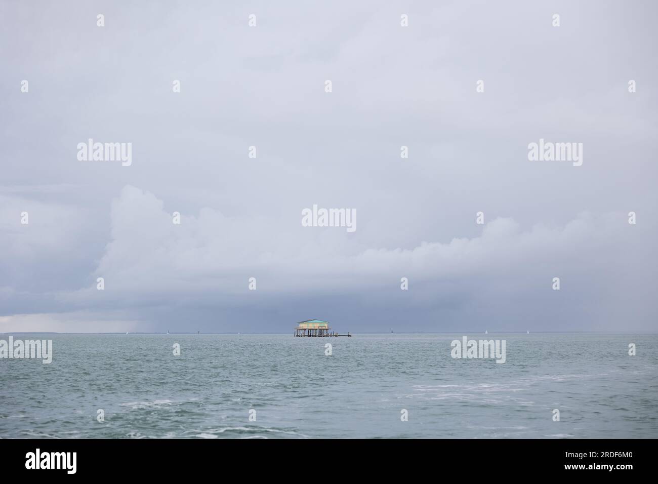 A house on stilts in the middle of the ocean Stock Photo