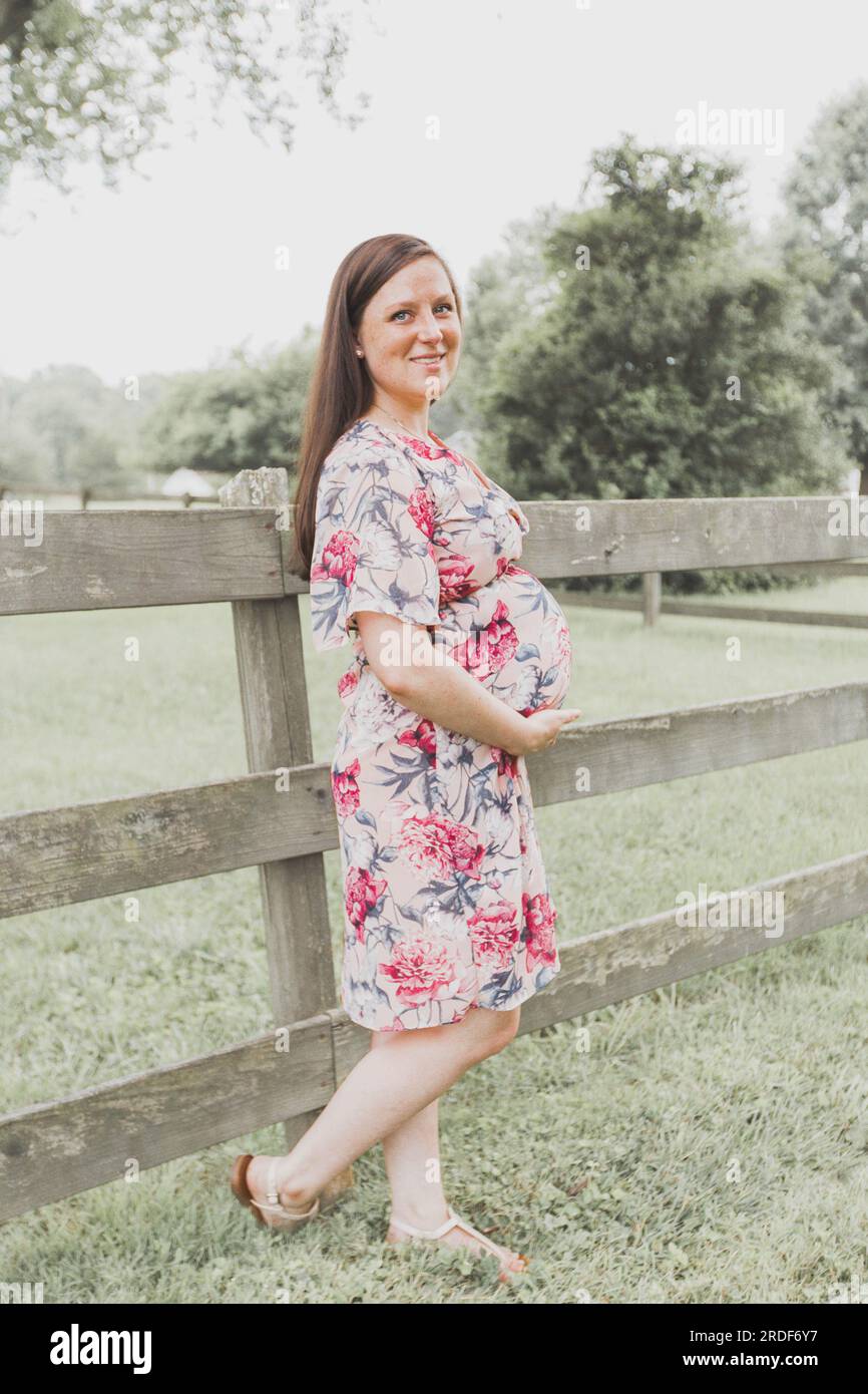 Pregnant Woman in Floral Dress Outside Stock Photo - Alamy