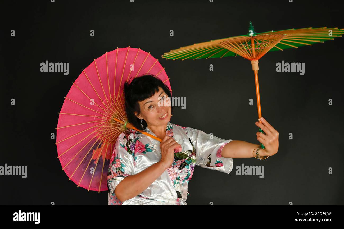 Asian dance with umbrellas Stock Photo