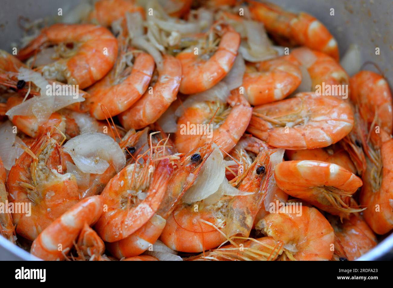 Pile of cooked shrimps with cumin, lemon and onion, a crustacean (a form of shellfish) with an elongated body and a primarily swimming mode of locomot Stock Photo