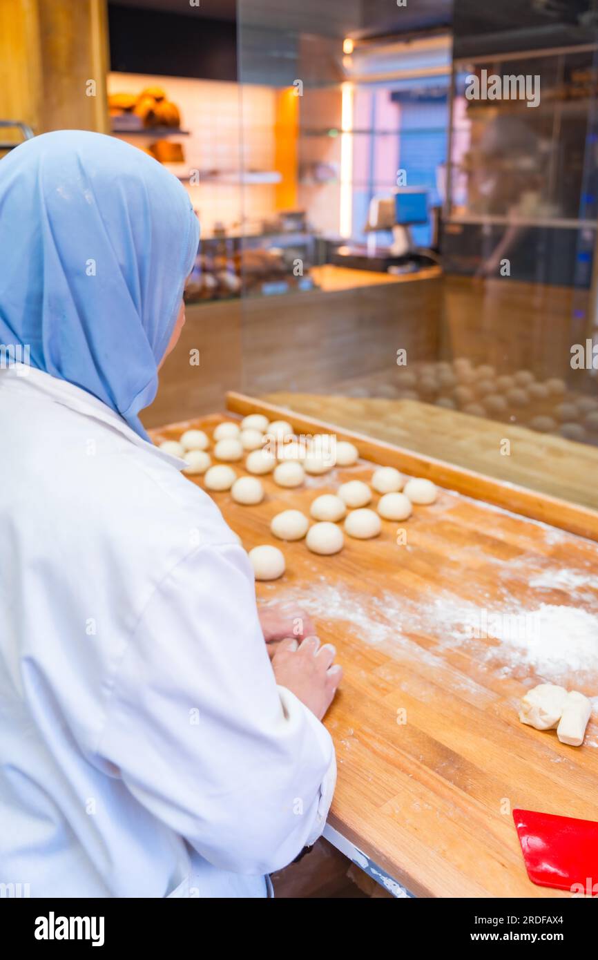 Arab woman baker in the bakery workshop workshop of artisan bakery ...