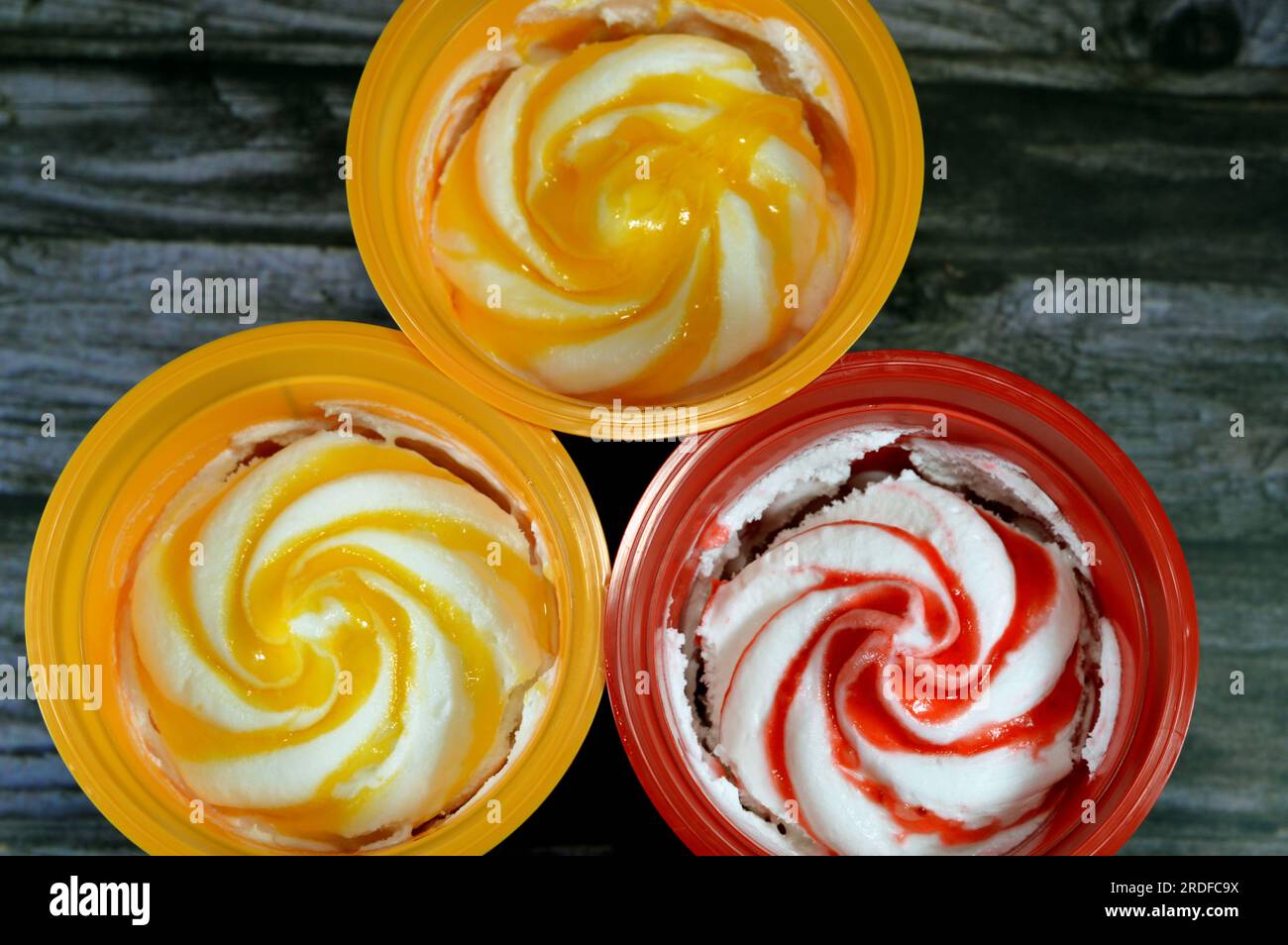 Mango and strawberry sauce ice cream frozen vanilla with fruit sauce