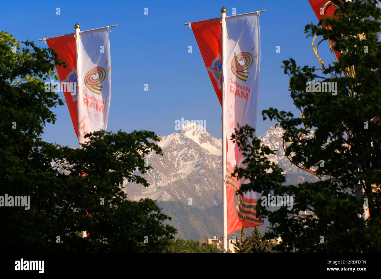 Flags in front of the Kungei-Alatau Mountains, view from Almaty, Kazakhstan, Kazakhstan, Kuengei Alatoo Stock Photo
