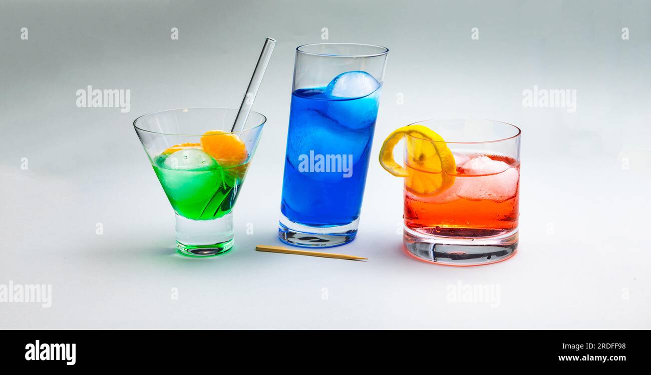 Three colorful long drinks with ice cubes released as a studio recording for the summer Stock Photo