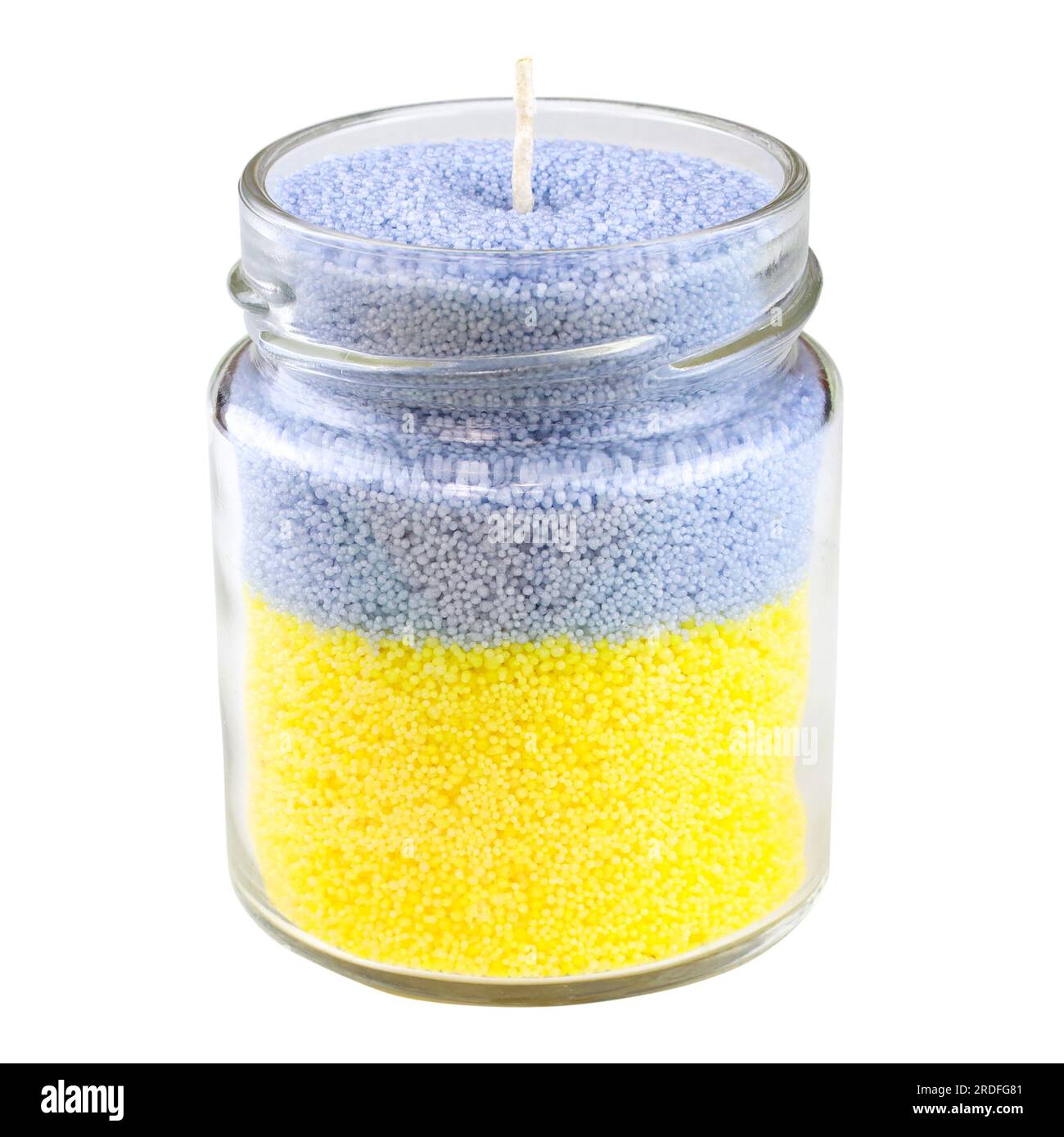 Candles in a jar closeup on white background. Making candles at home