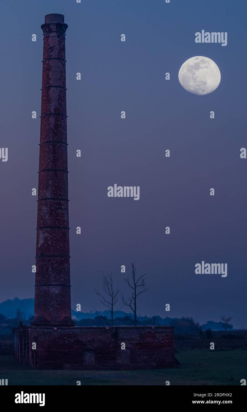 PHOTOGRAPH OF THE CHIMNEY OF LA TEJERA DE MURUETA TOGETHER WITH THE MOON, TAKEN WITH THE MULTIPLE EXPOSURE TECHNIQUE, IN MARCH 2023 Stock Photo