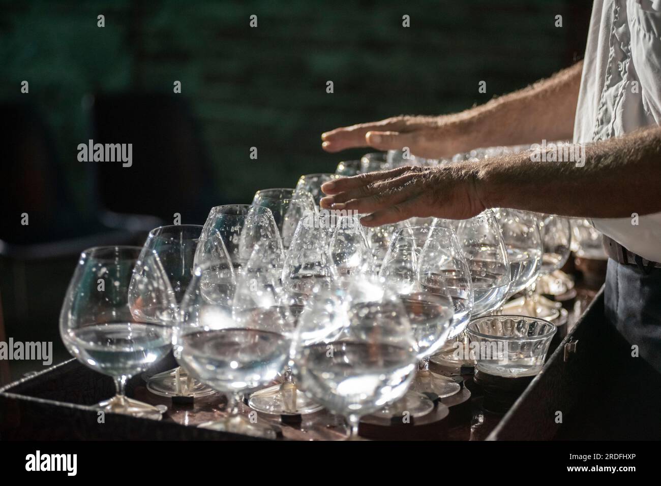 https://c8.alamy.com/comp/2RDFHXP/musician-plays-a-series-of-crystal-glasses-which-make-up-a-rare-instrument-called-the-glass-harp-2RDFHXP.jpg
