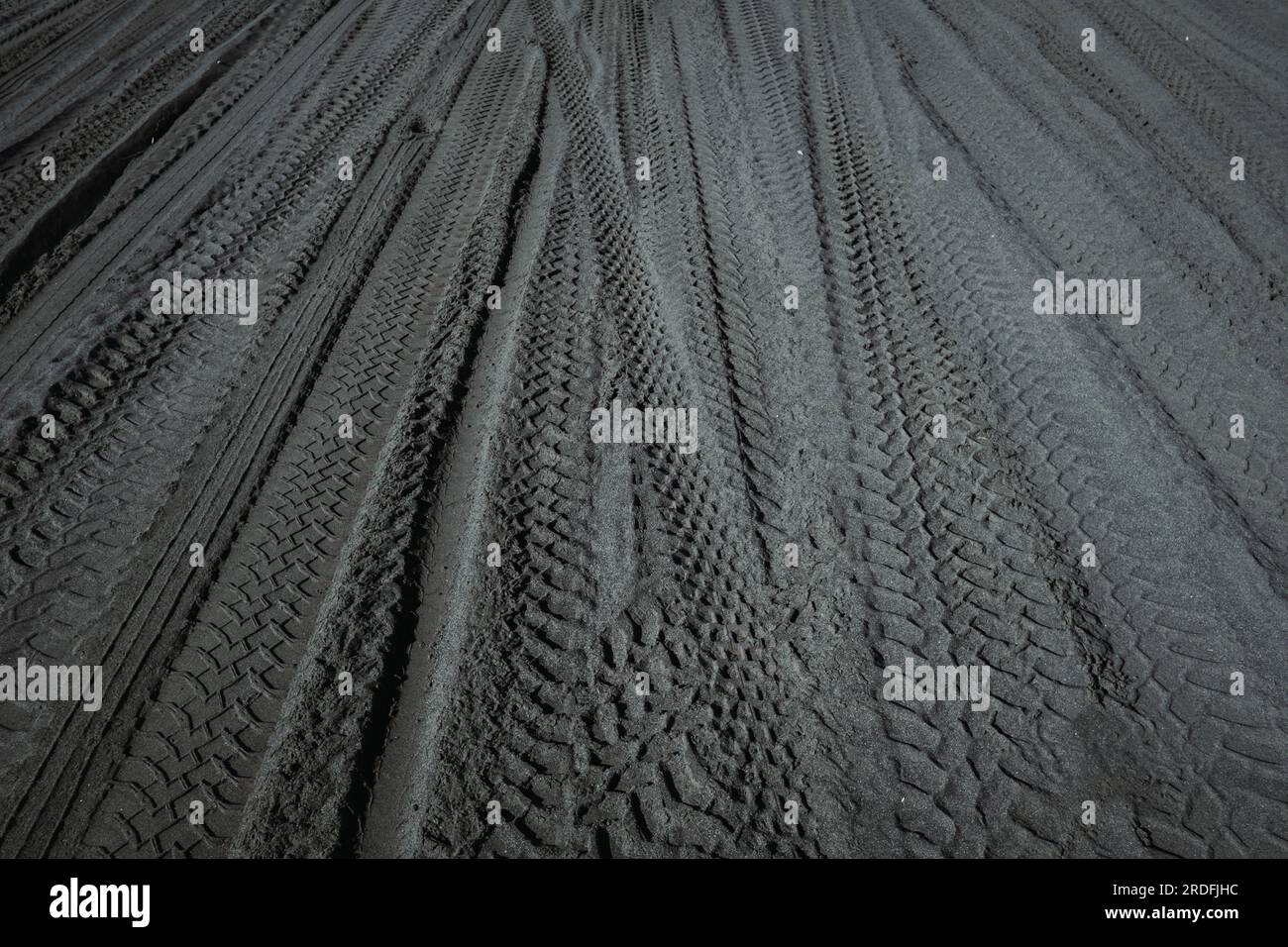 Offroad vehicle tracks on the black sand Stock Photo Alamy