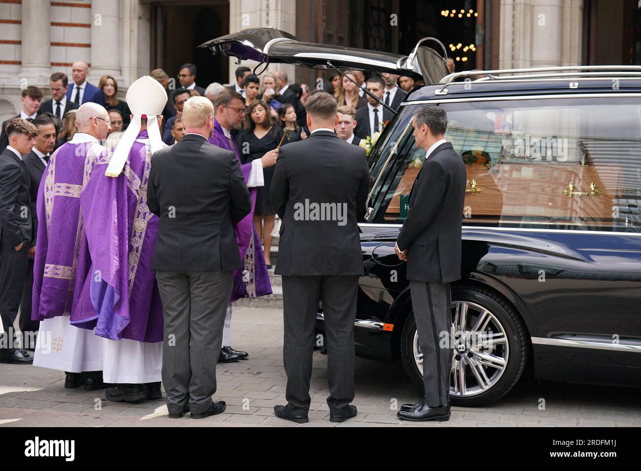 Members of the clergy bless the coffin of Grace O'MalleyKumar as it is