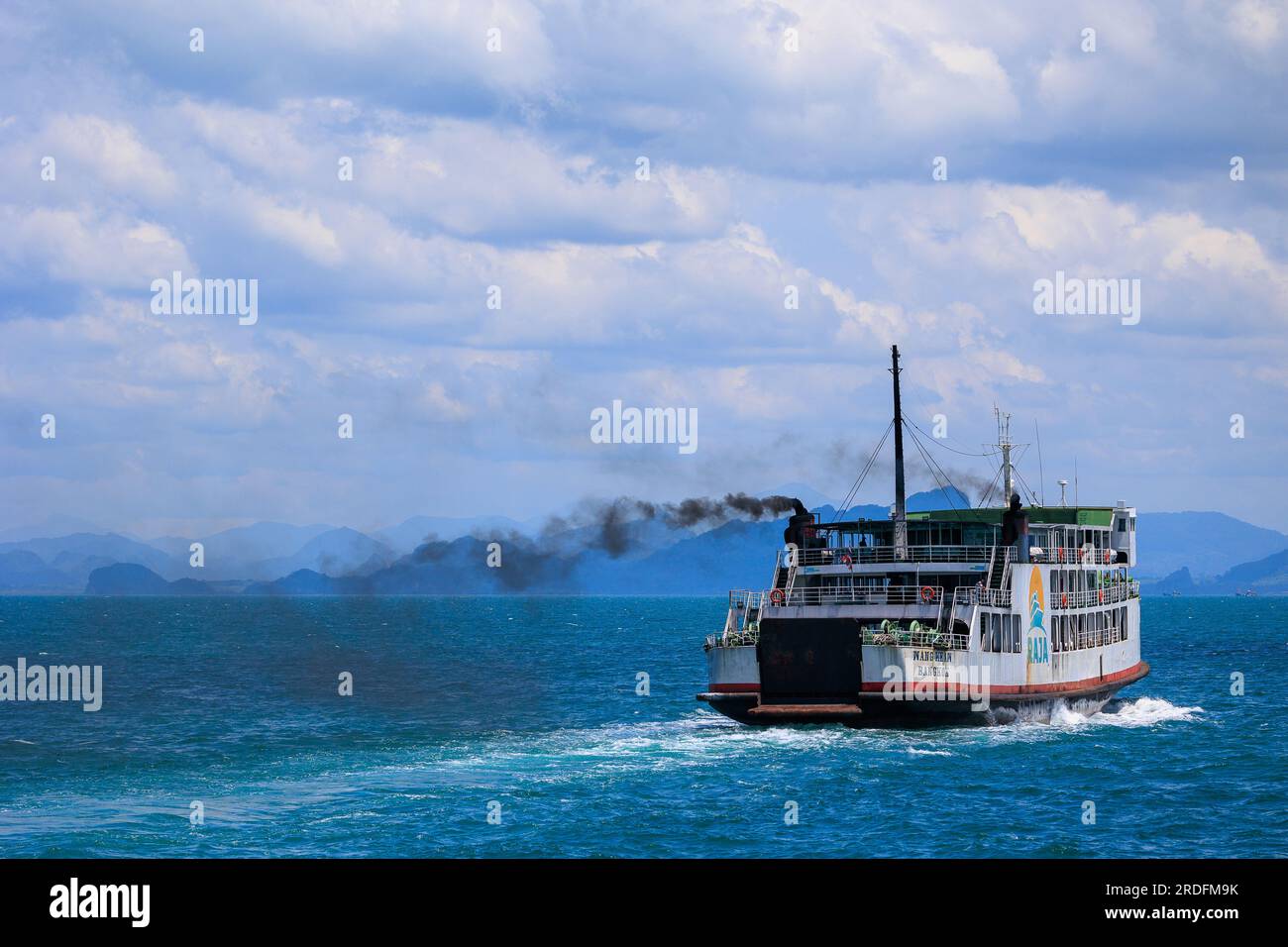 Ferry boat exhausting dark polluted smoke, Thailand Stock Photo