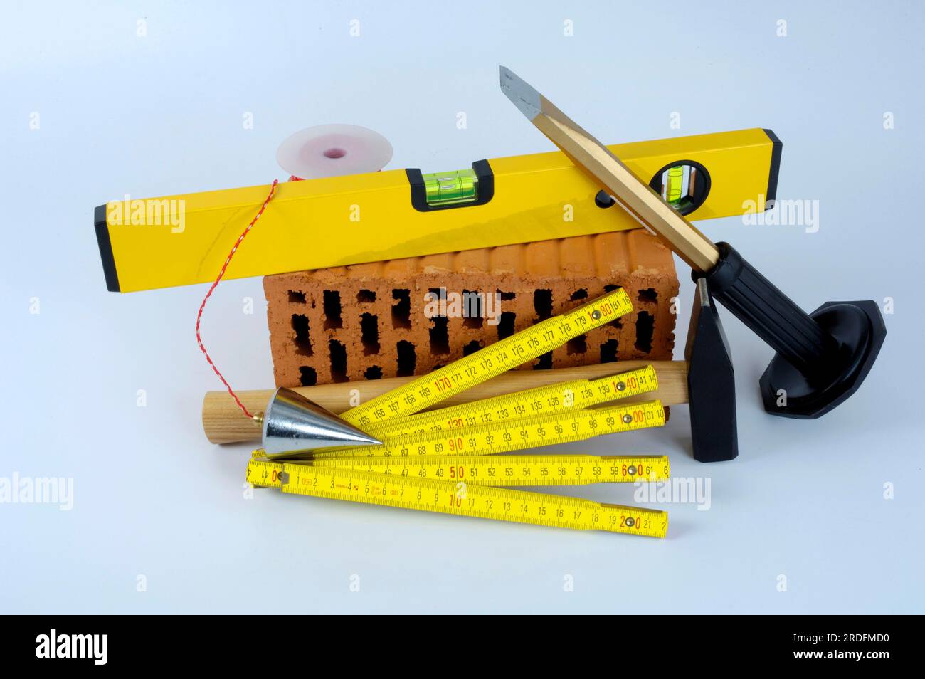 Brick, spirit level, hammer, chisel, plumb bob and scale, folding rule