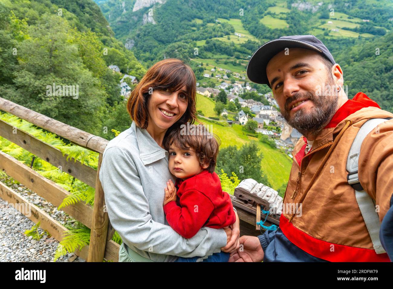 A family on a trail having fun in a Borce commune in the French Pyrenees and its beautiful mountains Stock Photo