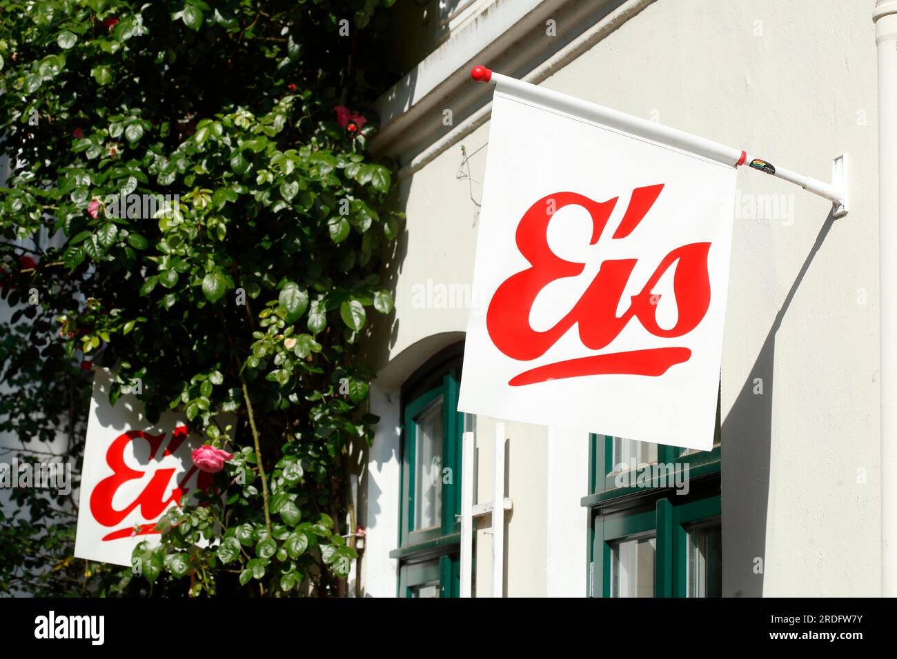 Red sign ice cream in front of an ice cream parlour, white background