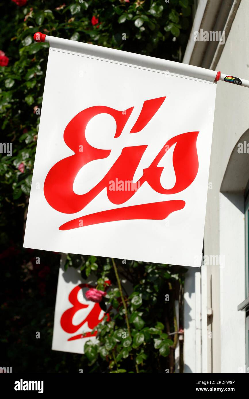Red sign ice cream in front of an ice cream parlour, white background