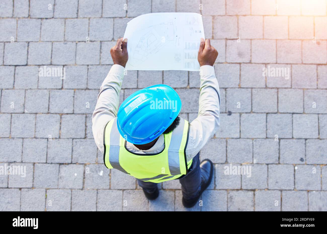 Construction worker, man and building inspection blueprint with ...