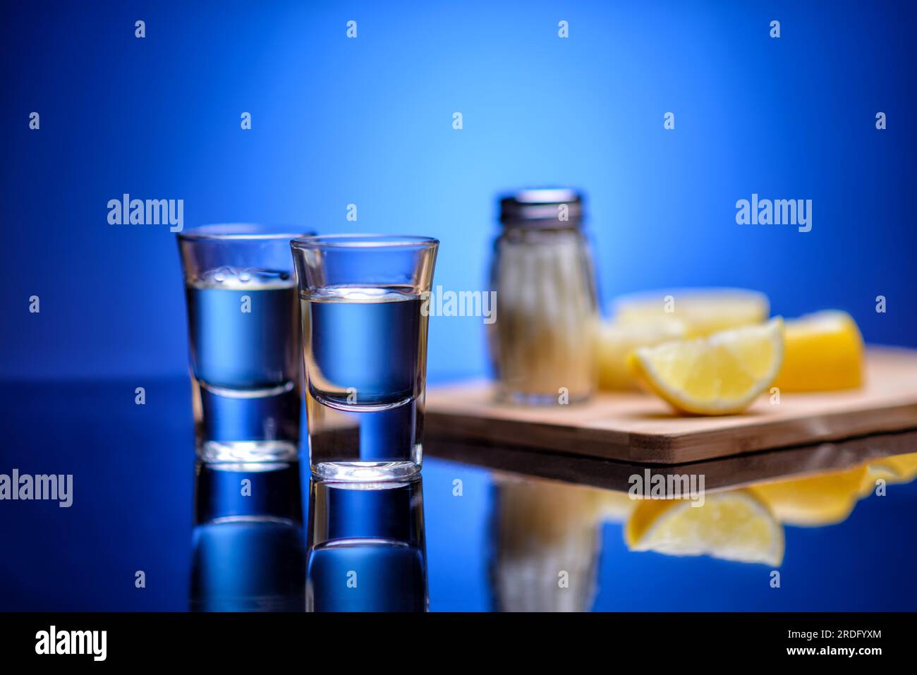 shot glasses with tequila, salt and lemons Stock Photo Alamy