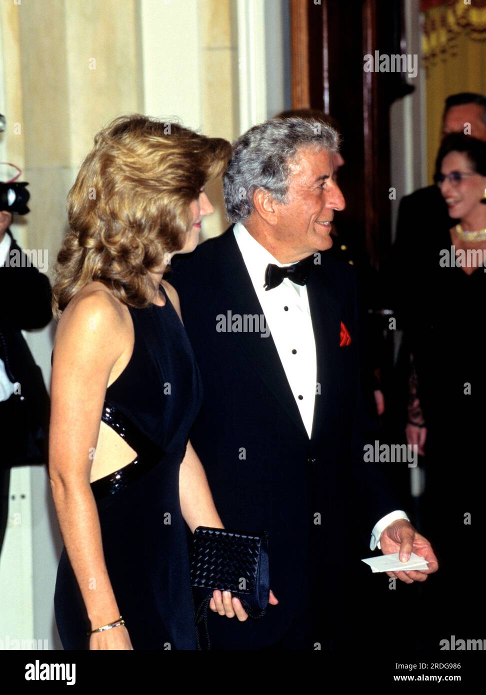 Singer Tony Bennett waits to be introduced to United States President Bill Clinton and first lady Hillary Rodham Clinton at the Official Dinner honoring Chancellor Helmut Kohl of Germany at the White House in Washington, DC for an Official Dinner on Thursday, February 9, 1995. Credit: John Harrington / Pool via CNP Stock Photo