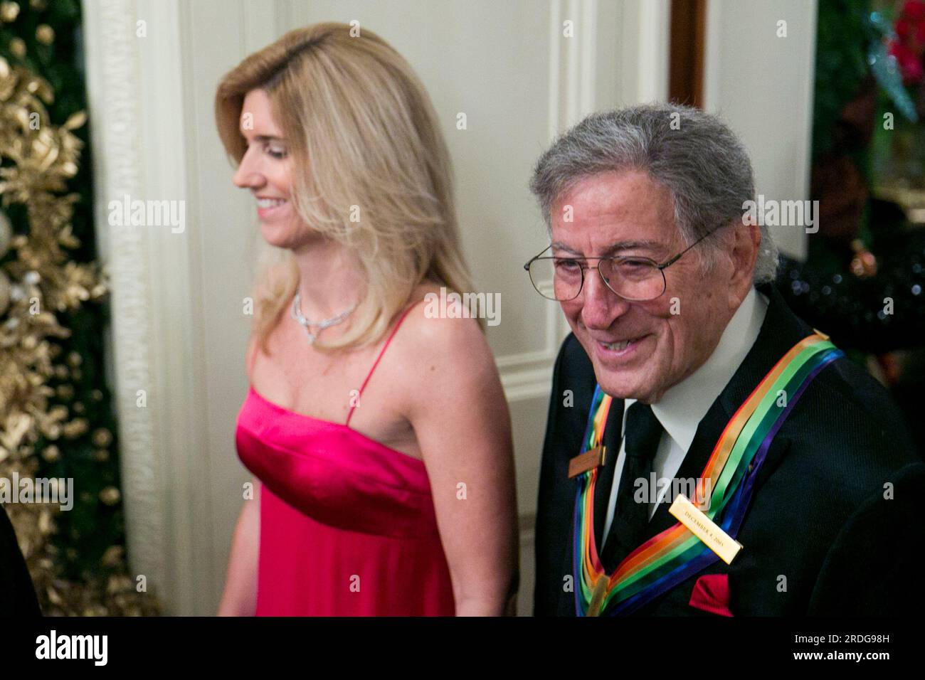 Tony Bennett and wife, Susan Crow attend a reception at the White House for the 2013 Kennedy Center Honorees on December 8, 2013 in Washington, DC. The honorees this year include: opera singer Martina Arroyo, jazz musician Herbie Hancock, musician Billy Joel, actress Shirley MacLaine and musician Carlos Santana. Credit: Kristoffer Tripplaar / Pool via CNP Stock Photo