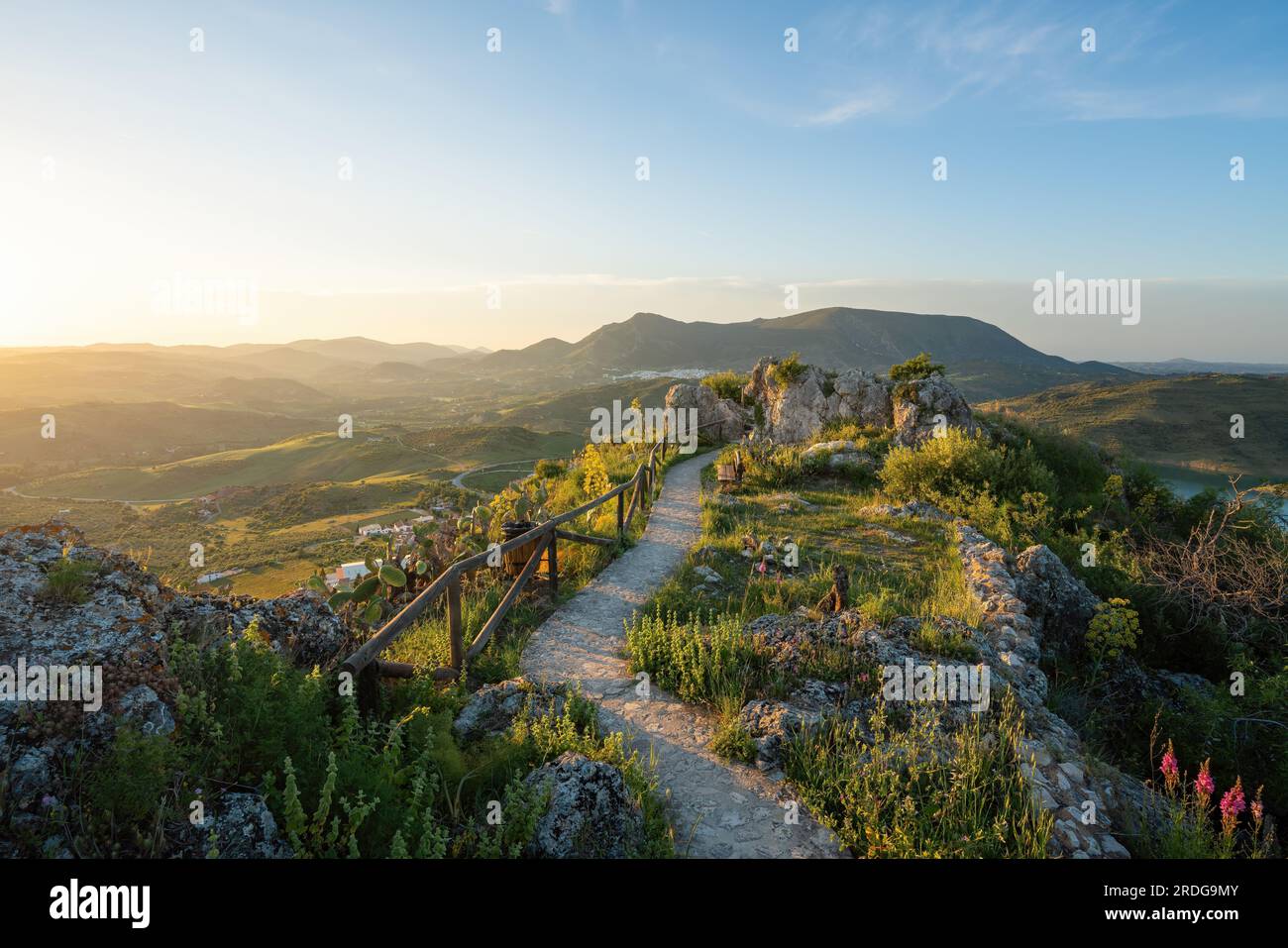 Walking path with wooden fence on the ruins of Zahara Castle at sunset - Zahara de la Sierra, Andalusia, Spain Stock Photo