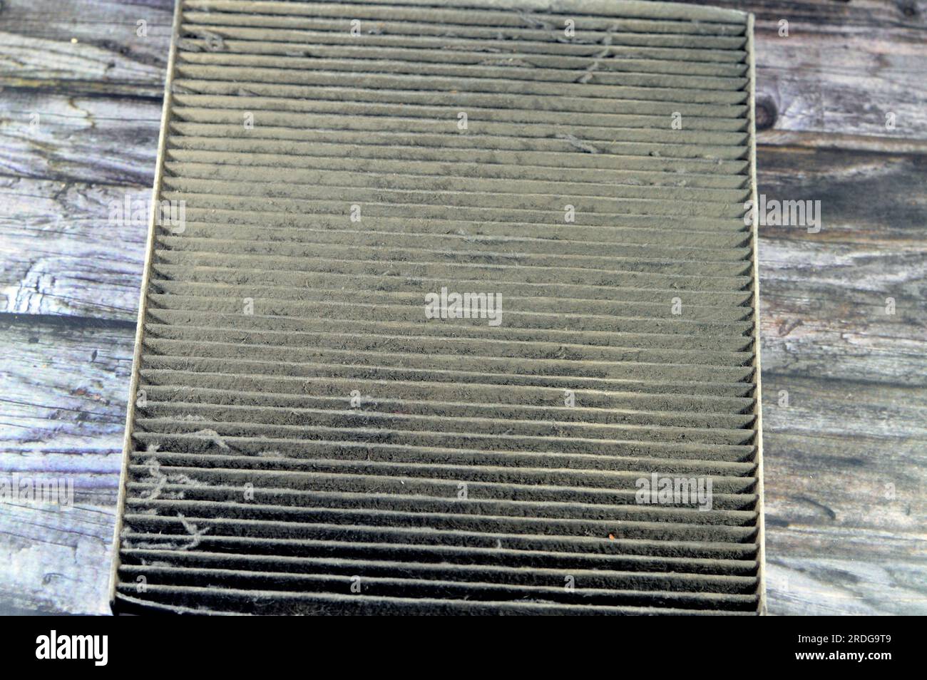 old dirty used car AC air conditioning filter full of dust removed from